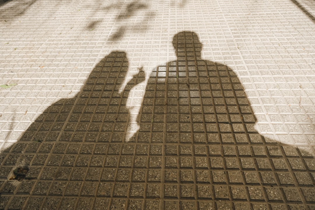 Person's shadow reaching for a cloud icon with security locks